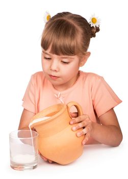 girl pours milk from a jug on a white