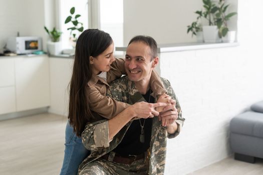 little girl looks at his military father. Lovely gaze of a daughter, holding hands.