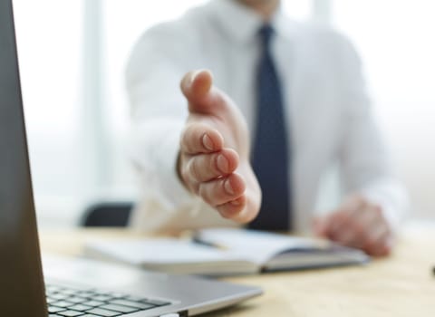 Smiling businessman pleased to meet you at office