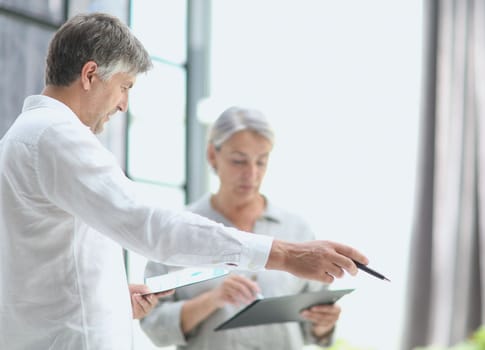 Businessman and woman working on computer together