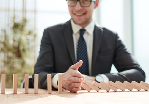 Businessman with dominoes in the office