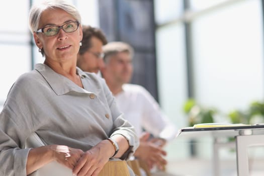 60 year old business woman in a work environment.