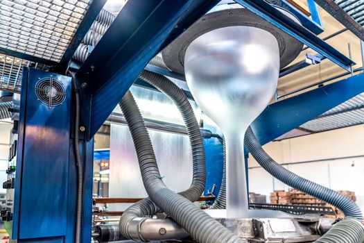 blowing plastic on a machine into a roll for the production of plastic bags.