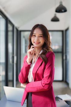 Beautiful asian business woman working at office. Financial analysis and tax concept.