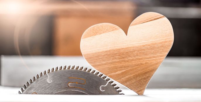 a heart made of wood on a circular in the joinery. I love wood. High quality photo