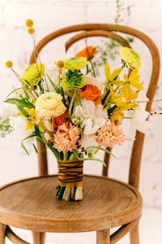 A bouquet of flowers in a pink box stands on a black and gray background. Flowers are white, pink, cream, of different sizes. Greeting card with the holiday. High quality photo