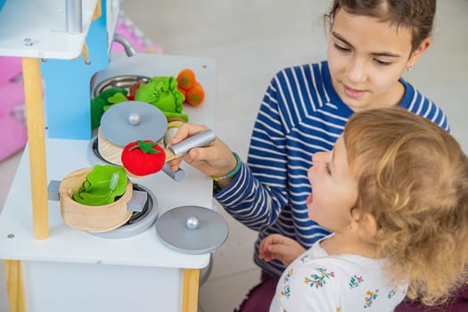 the child plays in the kitchen and cooks. Selective focus. Kid.