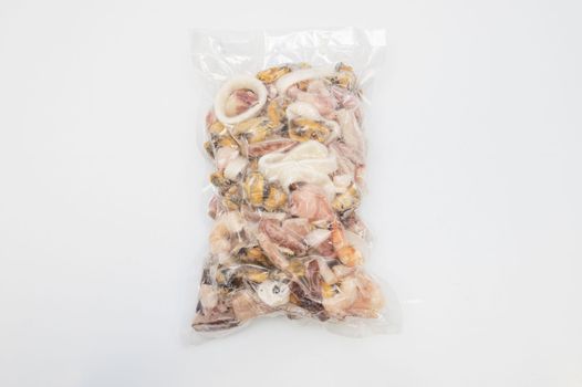 Pack of frozen seafood in hand on white backgound