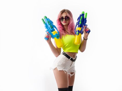 a girl with a water gun in summer clothes, slim and sexy, isolated on a white background drinking coffee