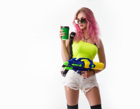 a girl with a water gun in summer clothes, slim and sexy, isolated on a white background drinking coffee