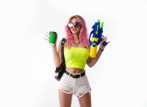 a girl with a water gun in summer clothes, slim and sexy, isolated on a white background drinking coffee