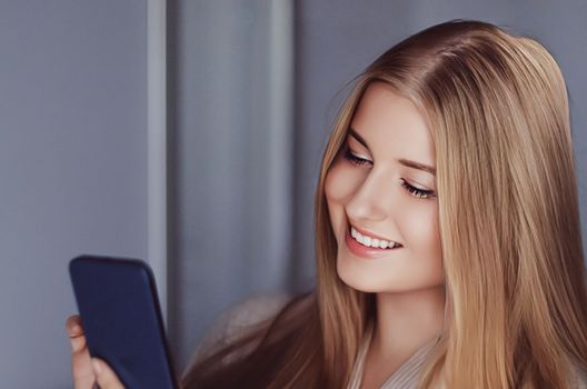 Beautiful woman having a video call and talking on mobile phone, girl doing online shopping on smartphone.