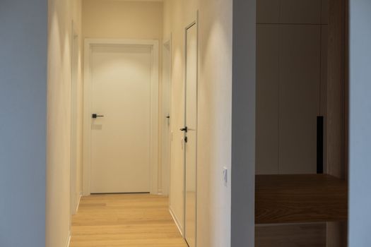 Bright white contemporary new home entrance hall to living room.