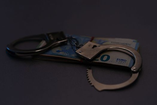 silver handcuffs on many large euro notes.