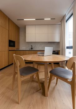 Interior of luxurious modern kitchen equipment, grey and oak cabinets.