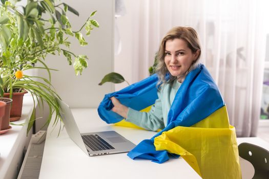 woman with flag of Ukraine and laptop.