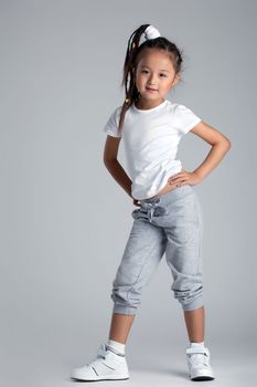 Full length portrait of asian little girl in sportswear