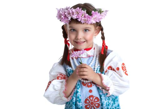 Pretty little girl in slavic costume and wreath of flowers smile. Isolated on white