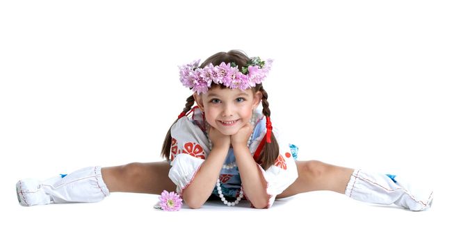 Full length portrait of little girl doing split in slavic costume and garland of flowers. Isolated on white