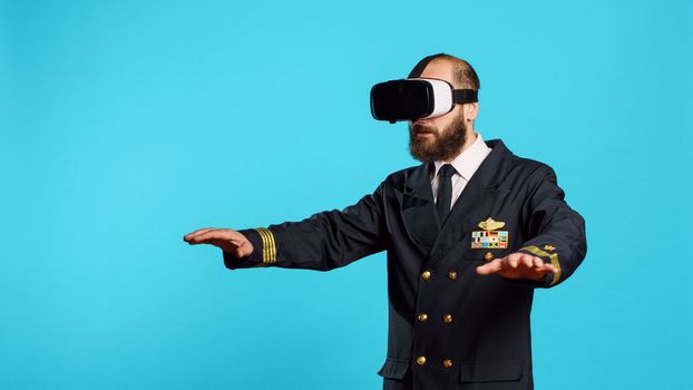 Plane captain using vr glasses interactive vision, having fun with virtual reality headset. Young aircraft pilot with flying aviaton uniform using 3d simulation goggles, aircrew member.