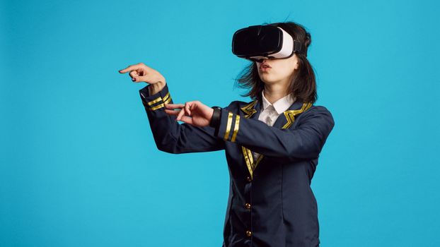 Stewardess using vr headset with interactive vision, having fun with virtual reality glasses. Cheerful air hostess dressed in flying uniform using 3d innovative goggles, professional airliner.