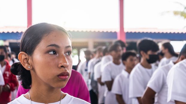 Young Latina student in the middle of a group of students