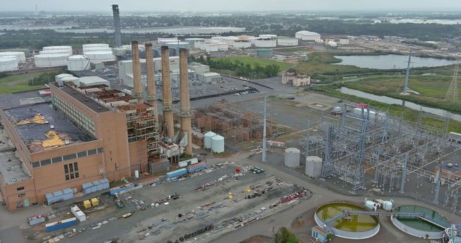 Non working old thermal power station located on coast of bay