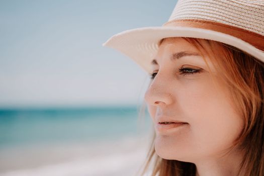 Young woman in red bikini on Beach. Blonde in sunglasses on pebble beach enjoying sun. Happy lady in one piece red swimsuit relaxing and sunbathing by turquoise sea ocean on hot summer day. Close up,