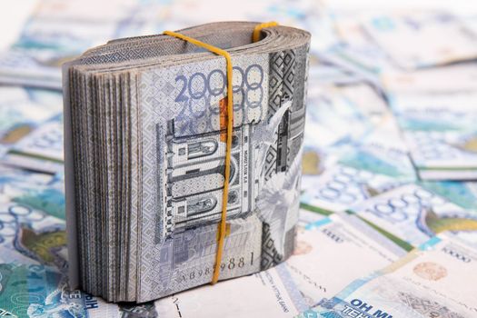 Pack of 20000 banknotes of Kazakhstan tenge, against the background of spread out Kazakhstani 10000 money.