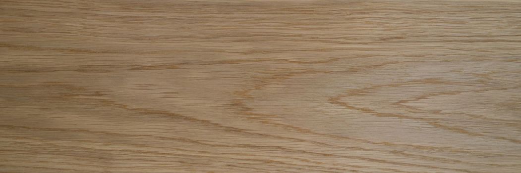 Wooden texture of laminate board or parquet closeup. Light yellow partially brown wooden texture concept