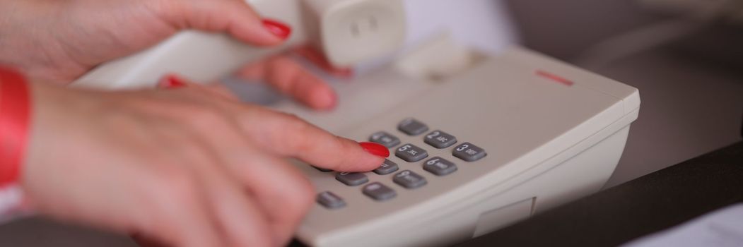 Business woman dialing phone number in hotel room. Hotel services and staff call concept