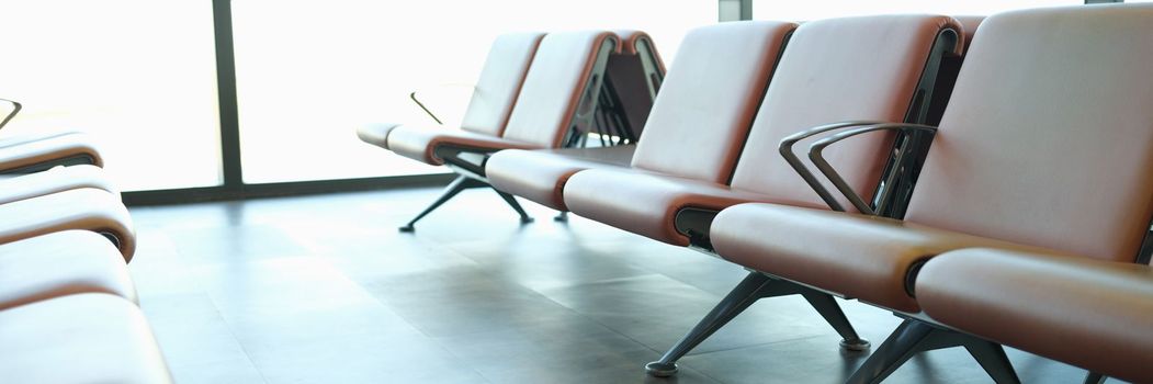 Location in airport terminal. Leather light brown armchairs at station station concept