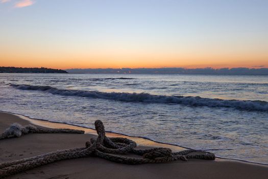 Scenic view of boat rope on the beach during morning