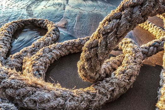 Old boat rope on the beach. Close up