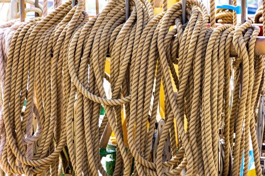 Old fashioned harbor marina sailboat ropes. Yachting details and objects concept.