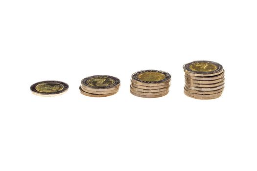 Coins stacked in piles, isolated in white.  Finance concept.