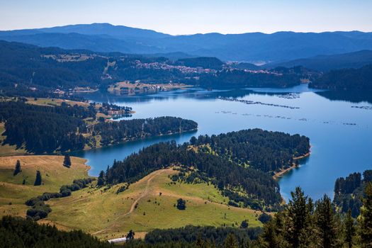 Amazing Aerial view of the blue water of a lake, Dospat Reservoir, Rhodopes Mountains, Bulgaria