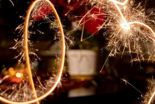 Background of glowing traces of sparklers. New year or holiday concept