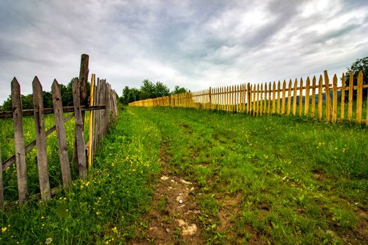 Timber plank fences and the country road between then