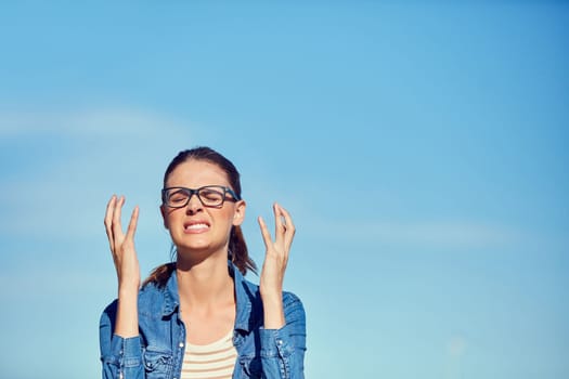 No No No. a young woman looking frustrated outdoors