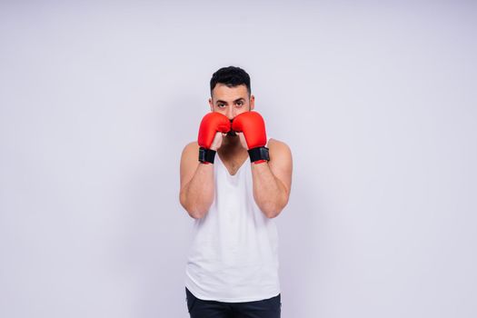 Young caucasian handsome man isolated on a white background with boxing gloves