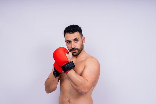 Young caucasian handsome man isolated on a white background with boxing gloves