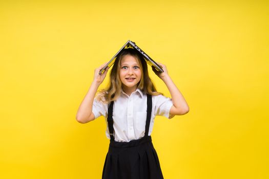 Little happy blonde kid girl 12-13 years laptop computer. Children lifestyle childhood concept.