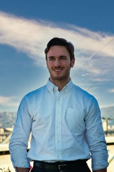 One handsome elegant young man in urban setting in city, standing