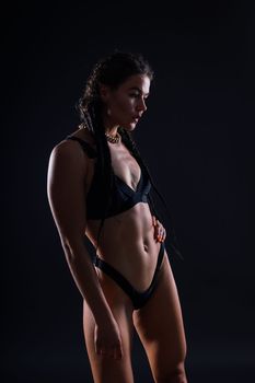 Close-up shot of young woman waist with muscular abdominal muscles. Abs of a fit female athlete.