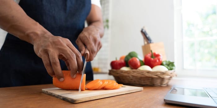 Closeup portrait of asian man making salad at home. cooking food and Lifestyle moment..