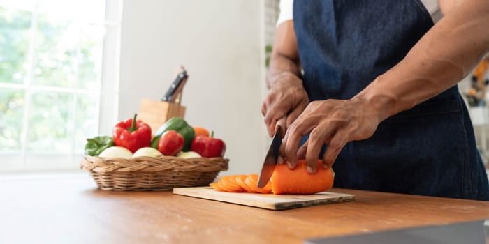 Closeup portrait of asian man making salad at home. cooking food and Lifestyle moment..