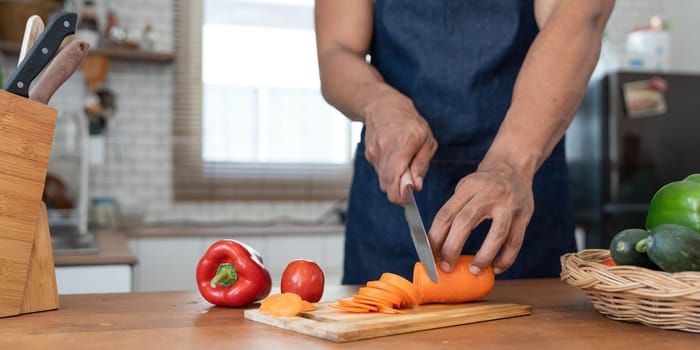 Closeup portrait of asian man making salad at home. cooking food and Lifestyle moment..