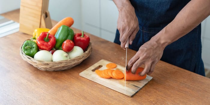 Closeup portrait of asian man making salad at home. cooking food and Lifestyle moment..