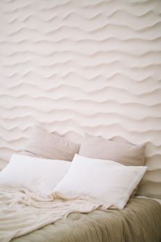 White bedroom interior. Stylish interior of contemporary room with comfortable bed.